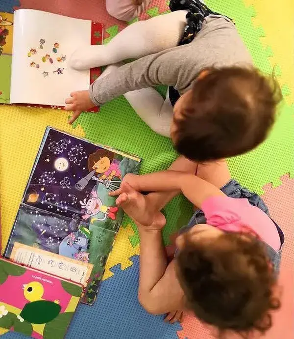 Toddlers looking at picture books together